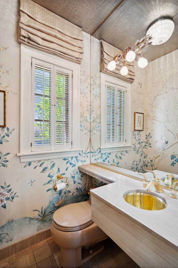 1140 Seneca Road Wilmette, IL 60091 - Photo 52 of 65 a bathroom with a sink a toilet and a mirror