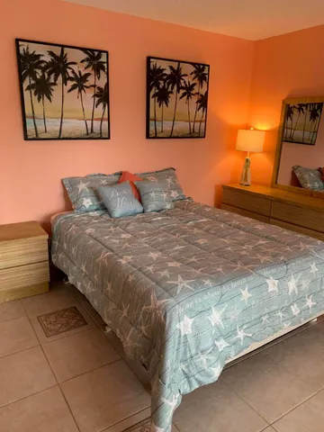 a bedroom with a bed and wall painting