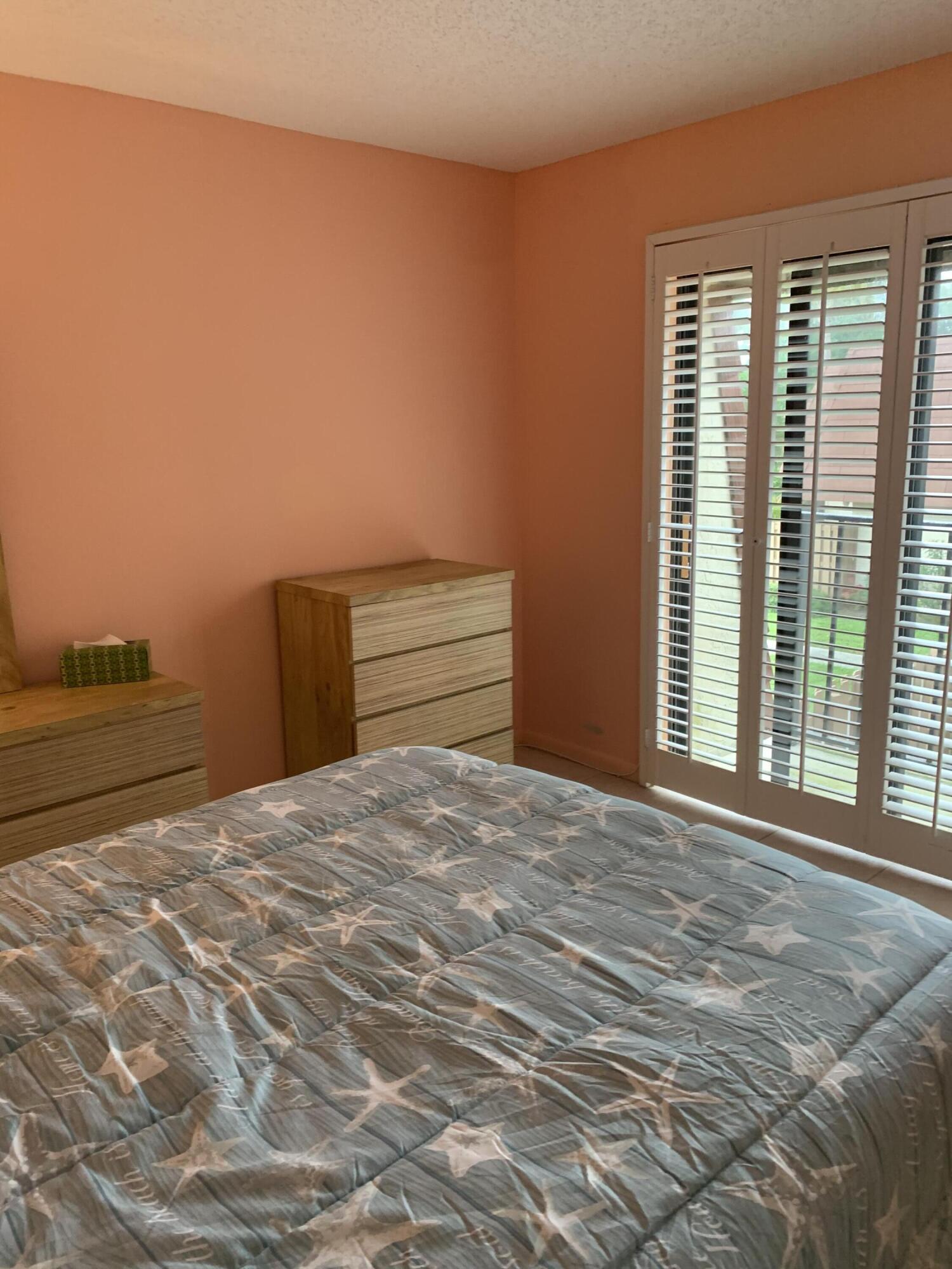 9403 South Ocean Drive, Unit 3D Jensen Beach, FL 34957 - Photo 13 of 15 a bedroom with a bed and a window