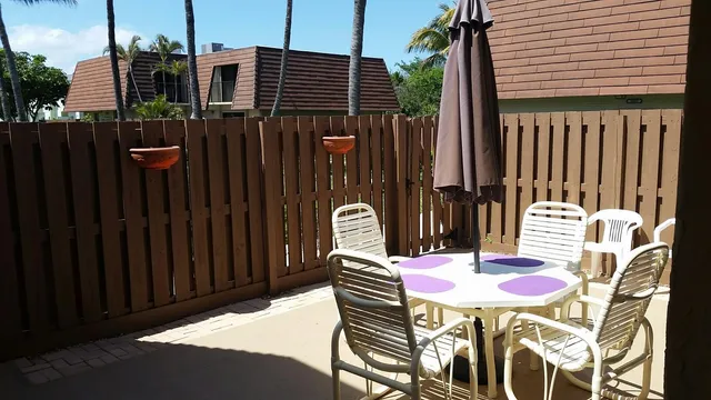 a backyard of a house with table and chairs