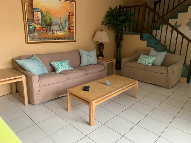 a living room with furniture and a painting