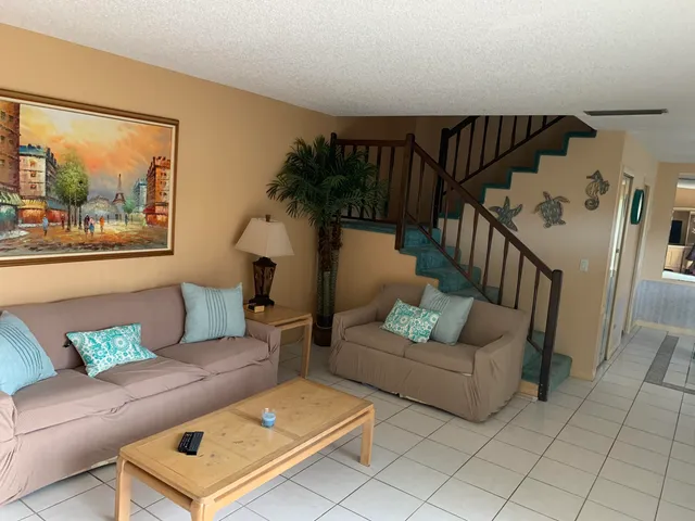 a living room with furniture and a painting