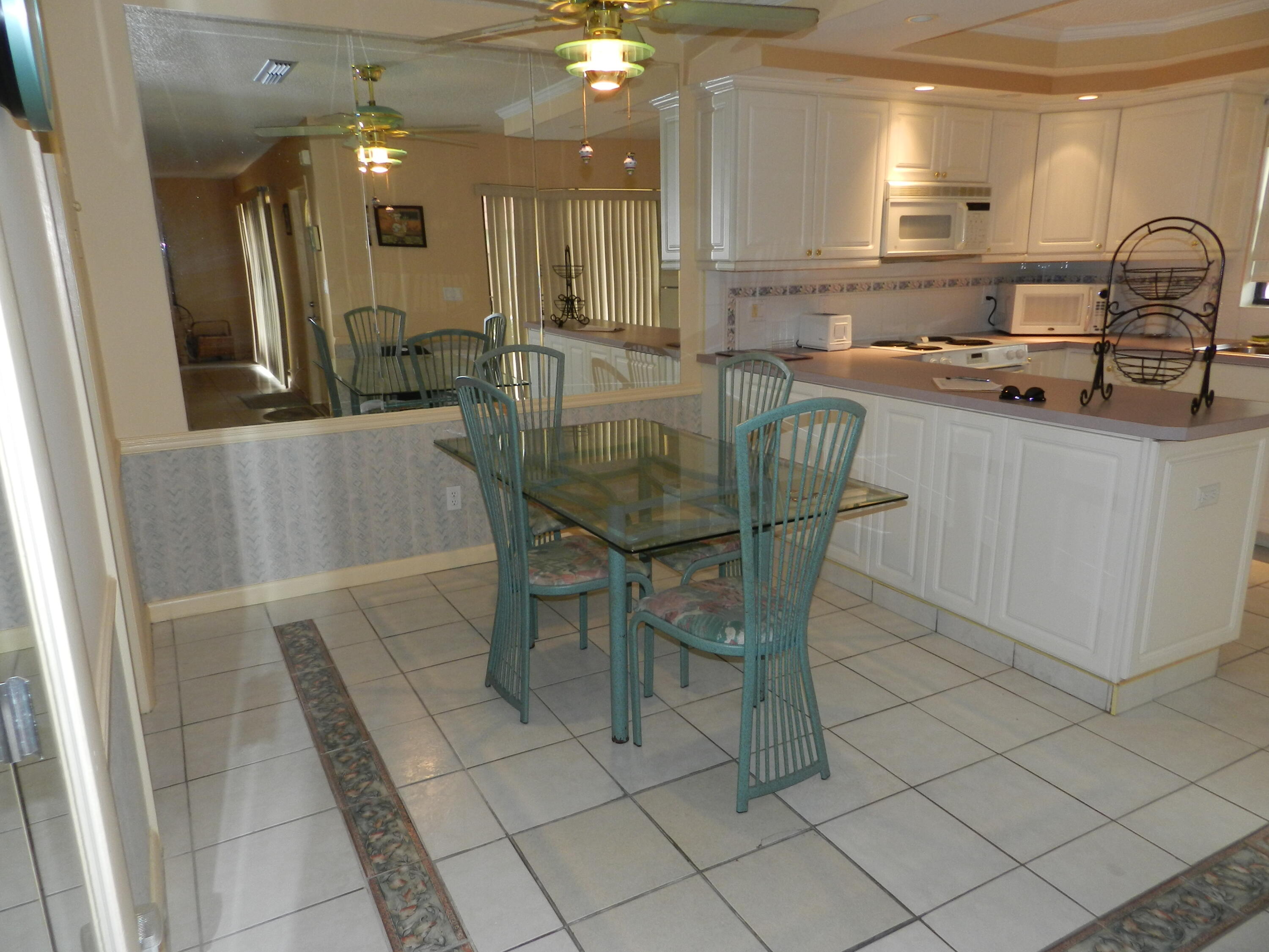 9403 South Ocean Drive, Unit 3D Jensen Beach, FL 34957 - Photo 7 of 15 a dining hall with stainless steel appliances a sink and dishwasher