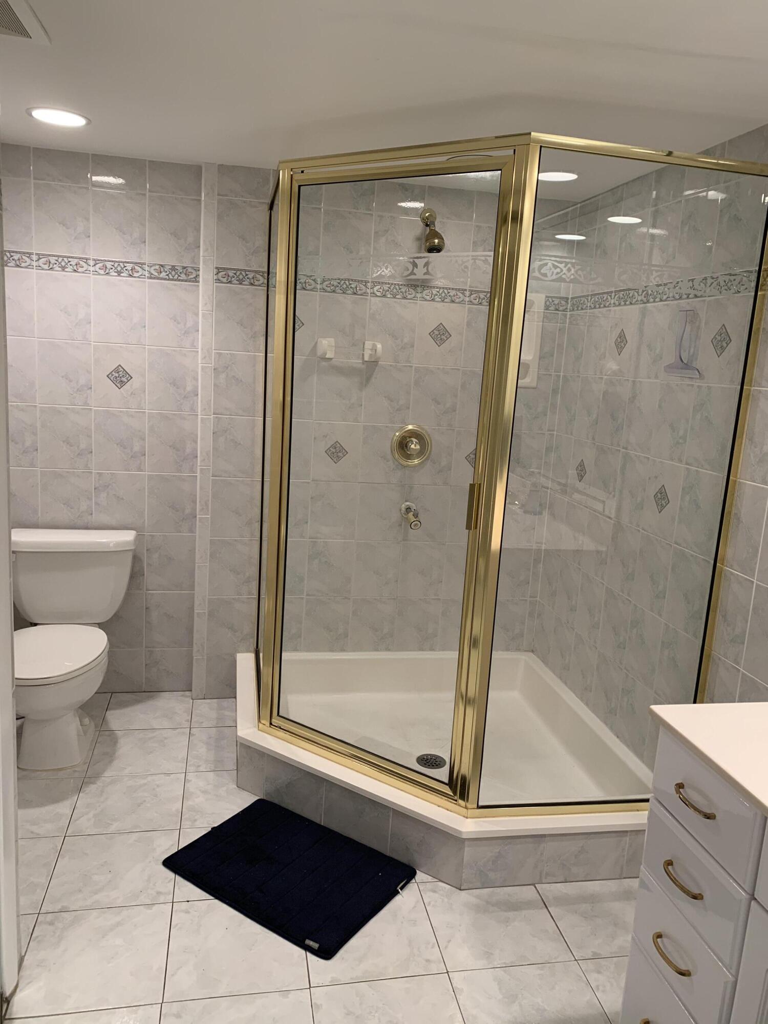 9403 South Ocean Drive, Unit 3D Jensen Beach, FL 34957 - Photo 10 of 15 a bathroom with a shower and a toilet