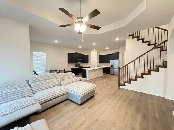 a view of a livingroom with furniture and a ceiling fan