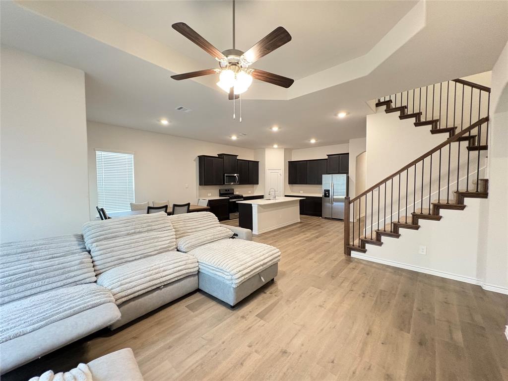 3823 Tack Aubrey, TX 76227 - Photo 11 of 27 a view of a livingroom with furniture and a ceiling fan