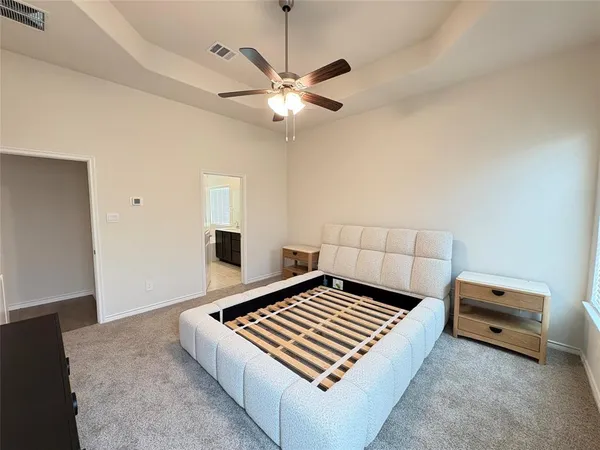 a living room with hard wood floor and a ceiling fan