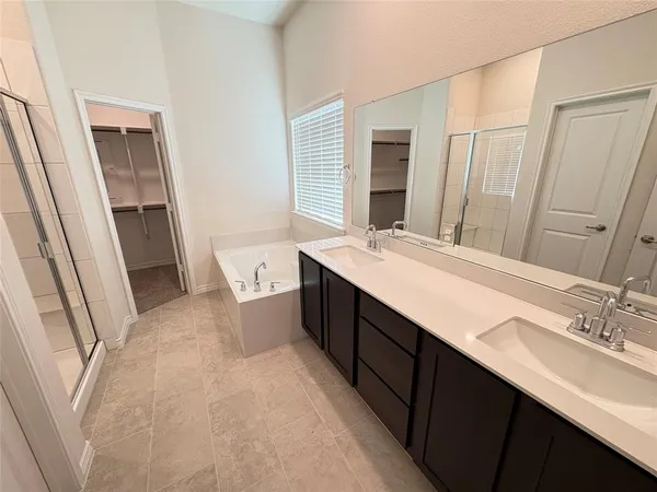 a bathroom with a double vanity sink a and mirror