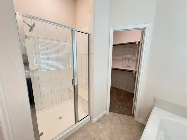 a bathroom with a shower and a sink