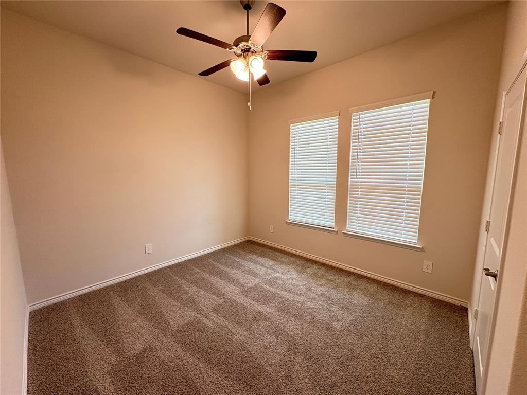 3823 Tack Aubrey, TX 76227 - Photo 23 of 27 an empty room with a window and a fan