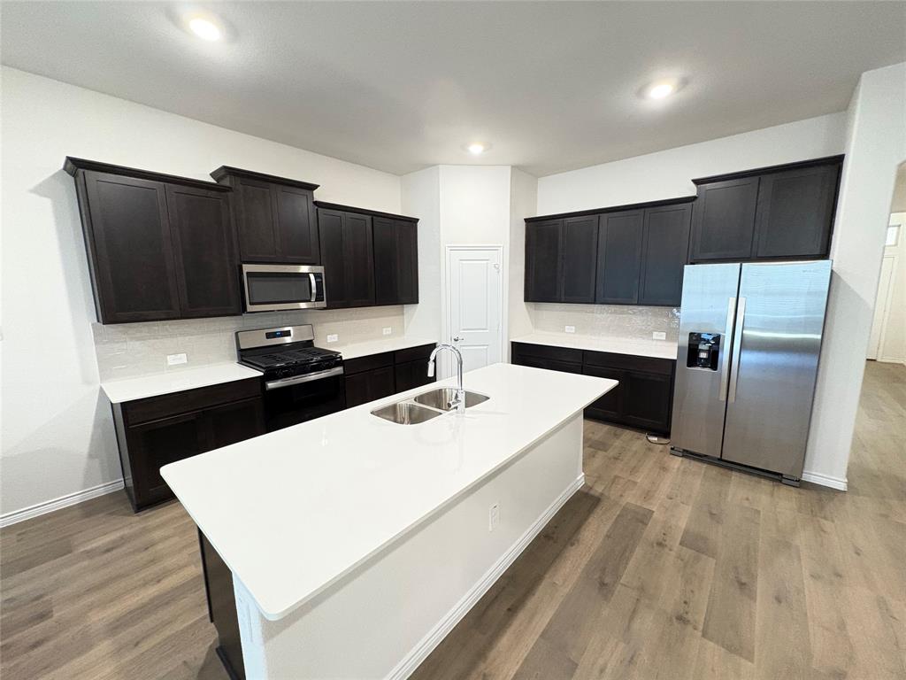 3823 Tack Aubrey, TX 76227 - Photo 6 of 27 a large white kitchen with a refrigerator and a sink