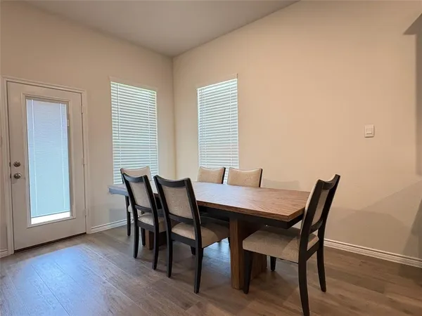 a view of a dining room with furniture and wooden floor