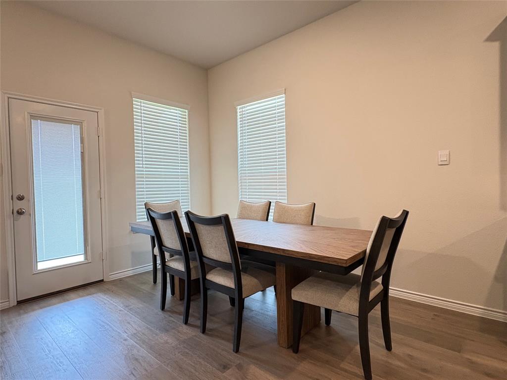 3823 Tack Aubrey, TX 76227 - Photo 9 of 27 a view of a dining room with furniture and wooden floor