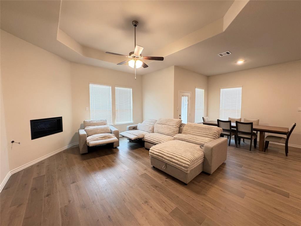 3823 Tack Aubrey, TX 76227 - Photo 10 of 27 a spacious bedroom with a bed a couch and a chandelier