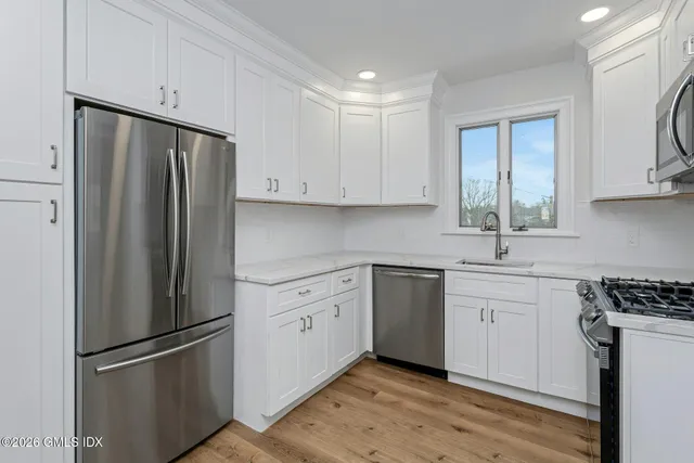 a kitchen with stainless steel appliances granite countertop a stove and a microwave