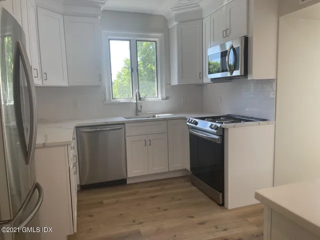 a kitchen with a stove sink and microwave