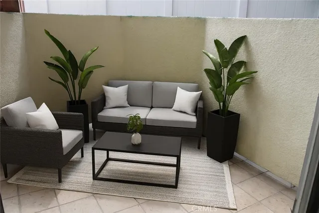 a living room with furniture and a potted plant