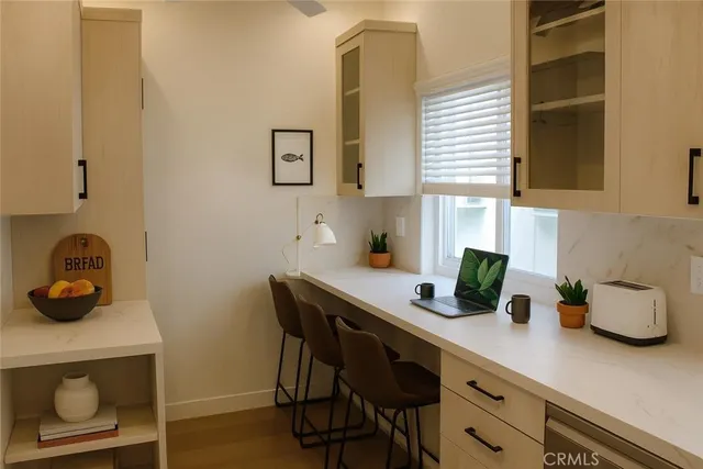 a kitchen with a sink cabinets and wooden floor