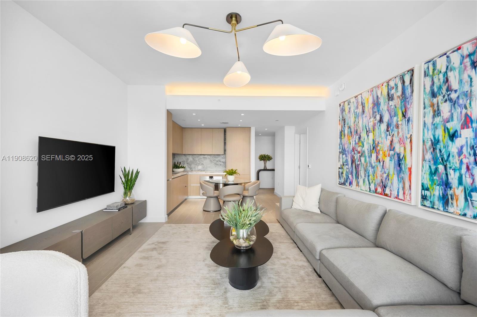 500 Alton Road, Unit 1904 Miami Beach, FL 33139 - Photo 11 of 28 a living room with furniture and a flat screen tv