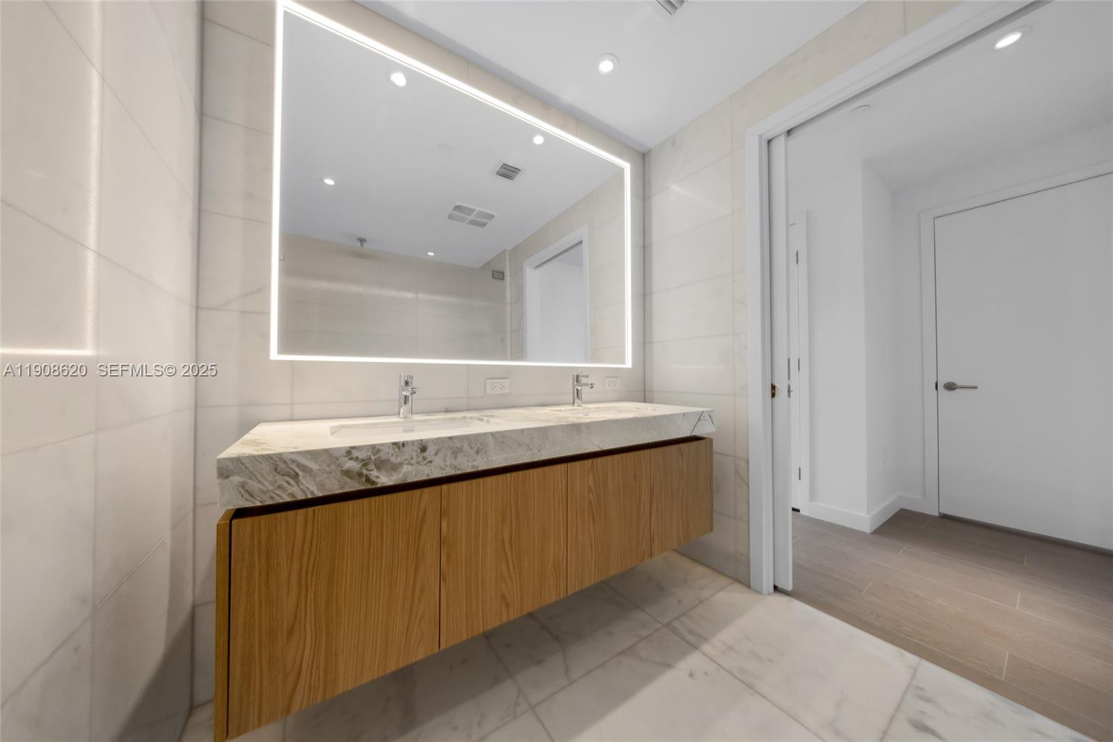 500 Alton Road, Unit 1904 Miami Beach, FL 33139 - Photo 20 of 28 a bathroom with a granite countertop sink and a mirror
