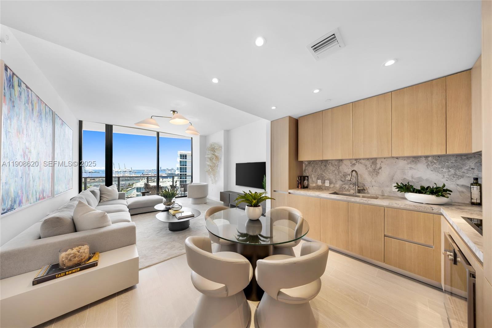 500 Alton Road, Unit 1904 Miami Beach, FL 33139 - Photo 8 of 28 a living room with fireplace furniture and a large window