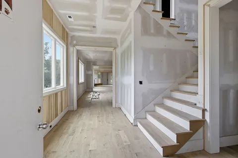a dining hall with stainless steel appliances granite countertop a stove and a sink