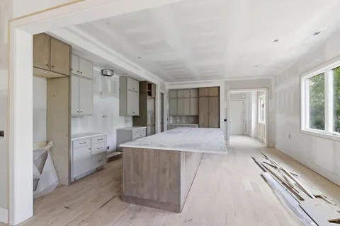 a kitchen with white cabinets and white appliances