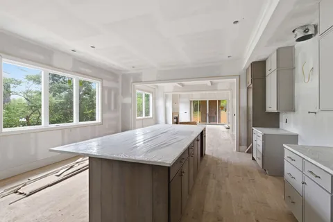 a kitchen with granite countertop cabinets appliances and a counter space