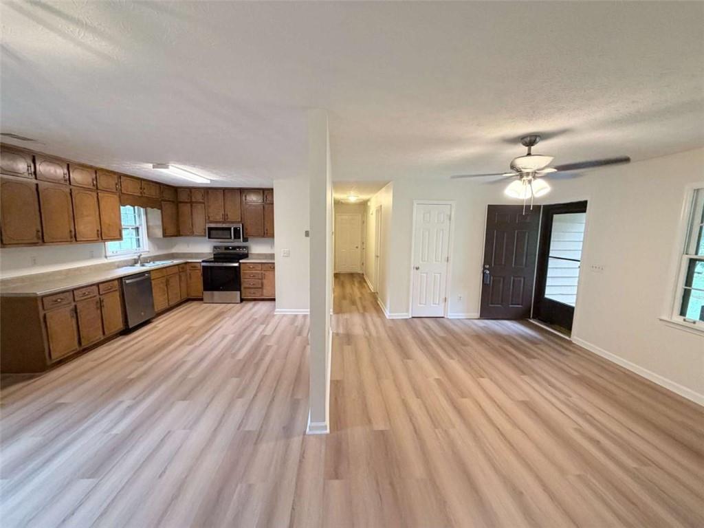 185 Roberts Road Covington, GA 30016 - Photo 11 of 25 a view of a kitchen with a sink and dishwasher a refrigerator with wooden floor
