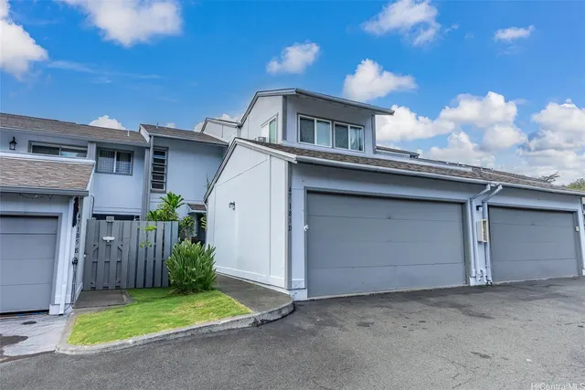 a view of a house with a yard and garage
