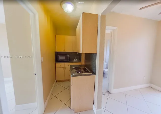 a kitchen with a refrigerator and cabinets