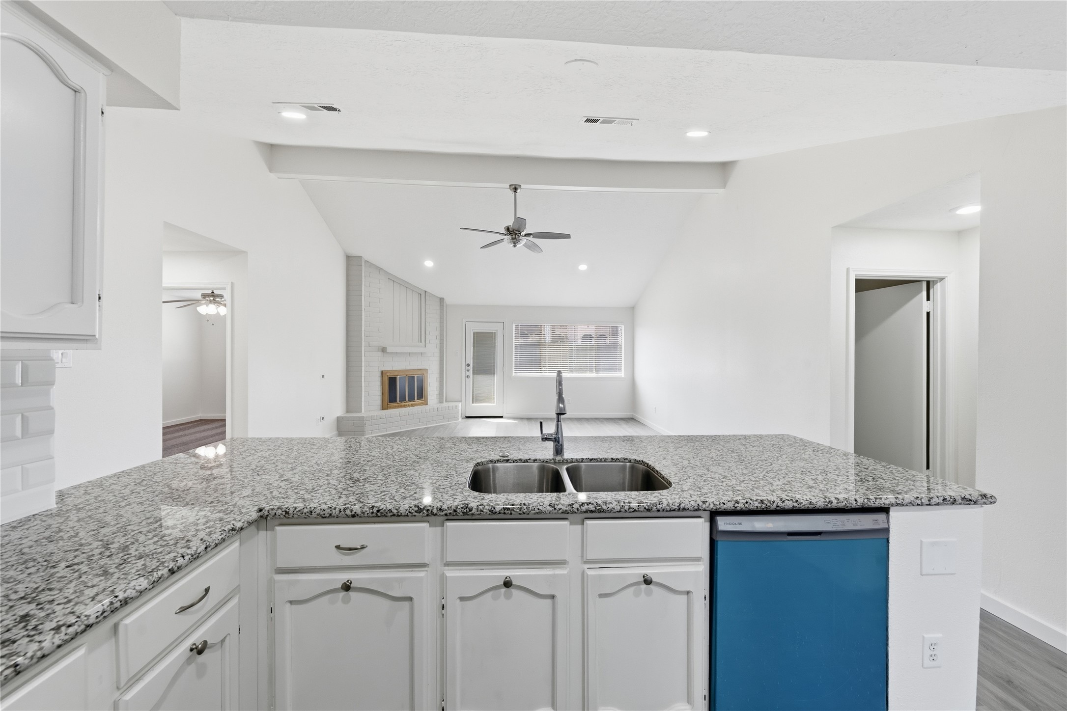 2303 Keyhole Lane Houston, TX 77084 - Photo 10 of 28 a kitchen with granite countertop a sink and white cabinets