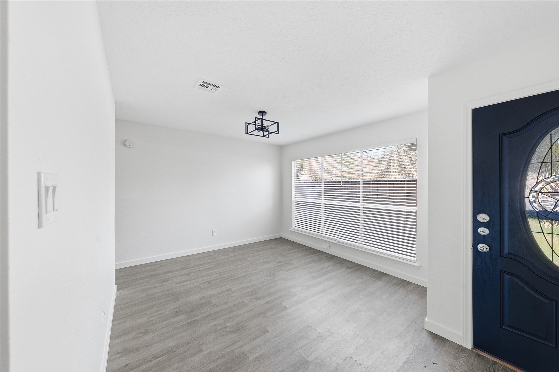 2303 Keyhole Lane Houston, TX 77084 - Photo 2 of 28 an empty room with wooden floor and windows