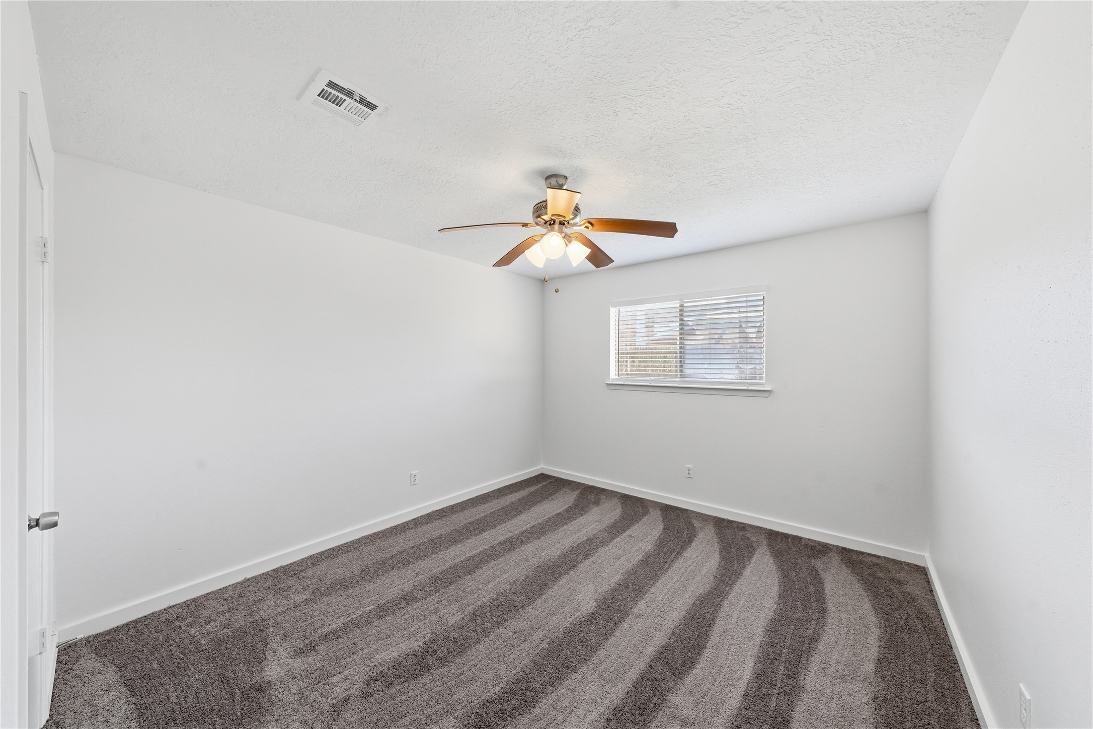 2303 Keyhole Lane Houston, TX 77084 - Photo 24 of 28 a view of a room with wooden floor and fan