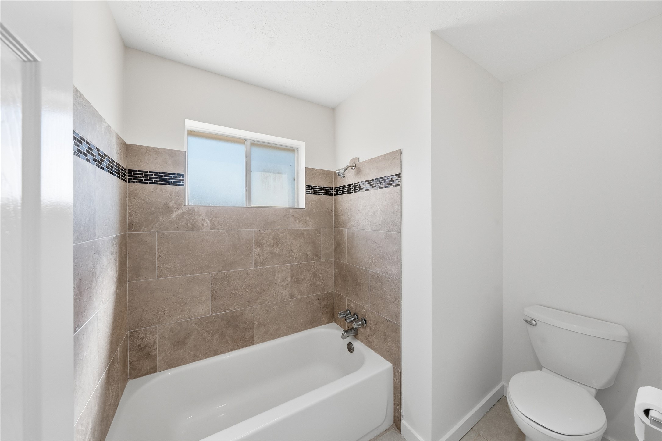 2303 Keyhole Lane Houston, TX 77084 - Photo 26 of 28 a bathroom with a toilet and a bathtub