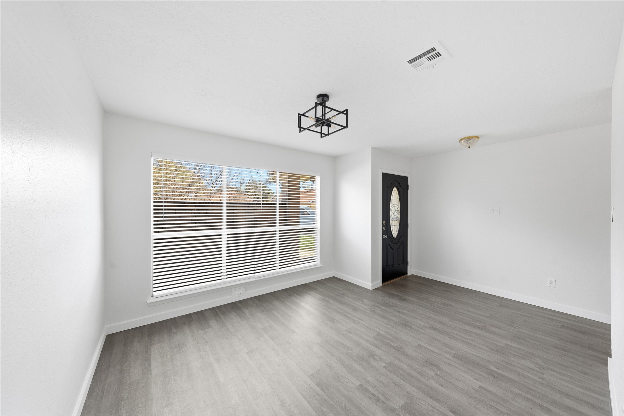 2303 Keyhole Lane Houston, TX 77084 - Photo 3 of 28 an empty room with wooden floor and windows
