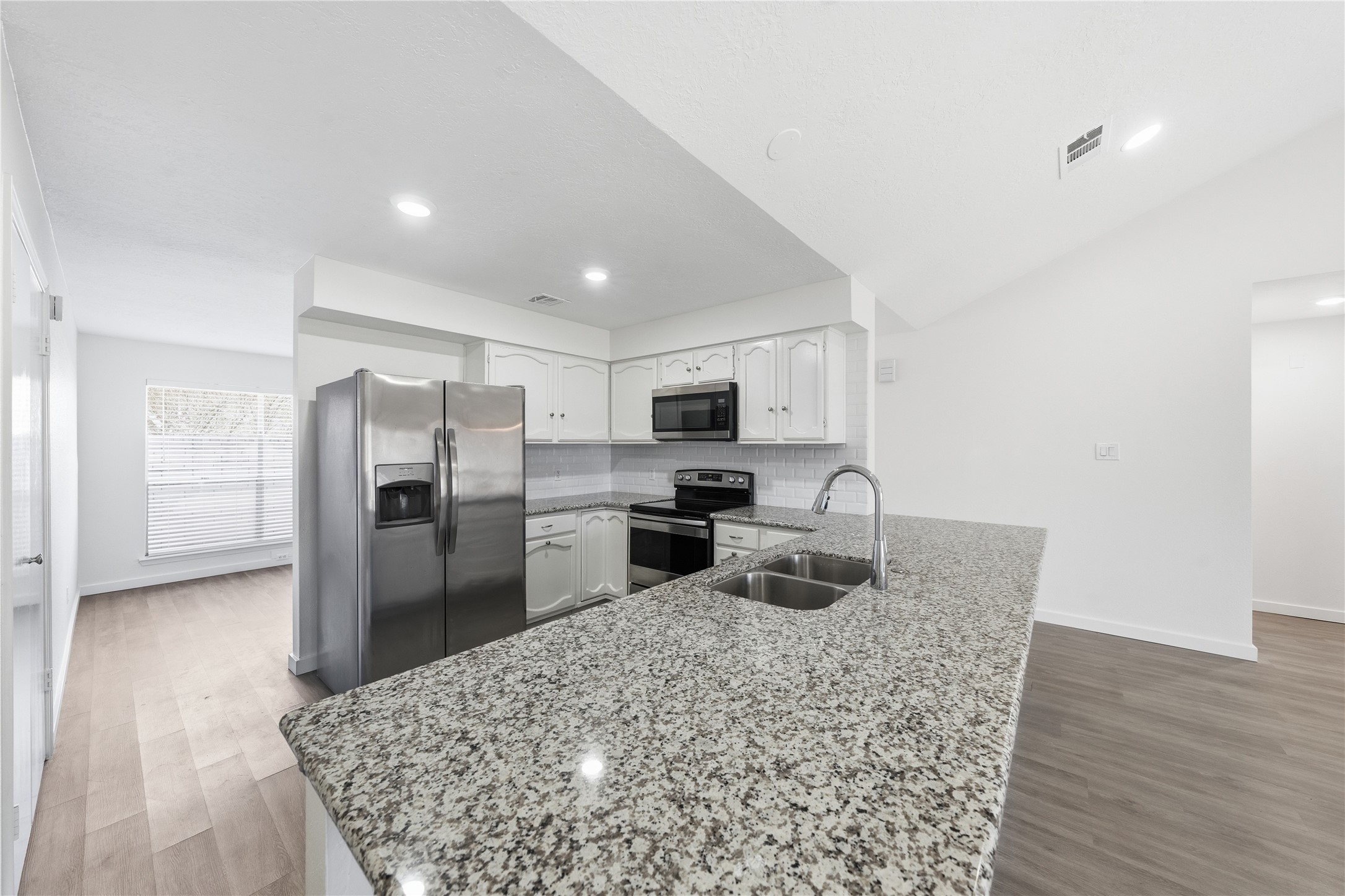 2303 Keyhole Lane Houston, TX 77084 - Photo 7 of 28 a kitchen with refrigerator and microwave