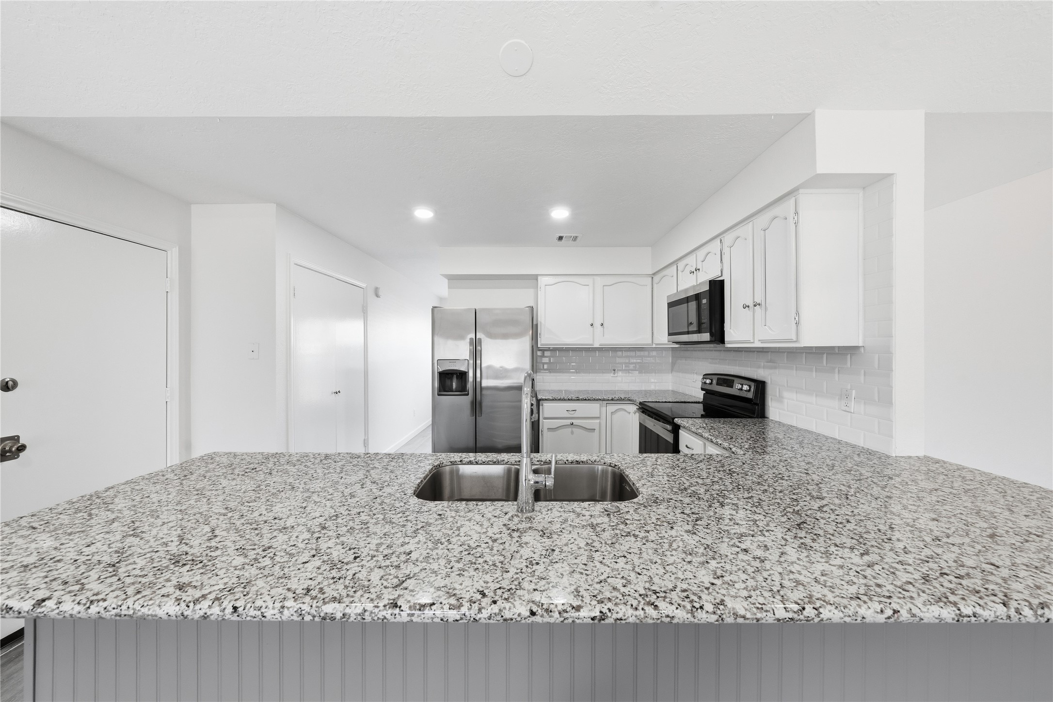 2303 Keyhole Lane Houston, TX 77084 - Photo 8 of 28 a kitchen with stainless steel appliances granite countertop a sink refrigerator and cabinets