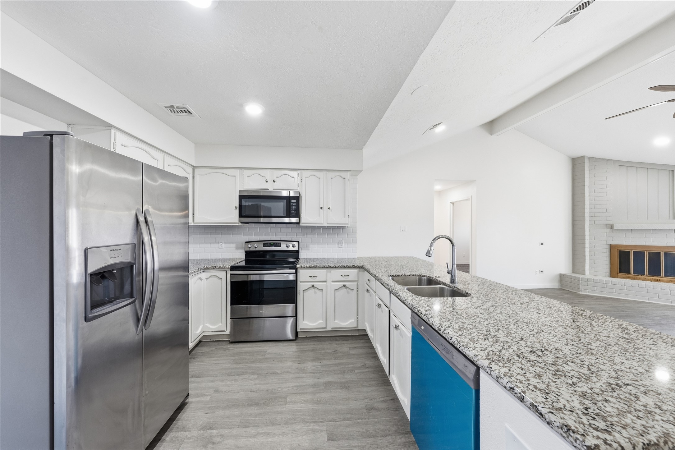 2303 Keyhole Lane Houston, TX 77084 - Photo 9 of 28 a kitchen with stainless steel appliances granite countertop a sink stove and refrigerator