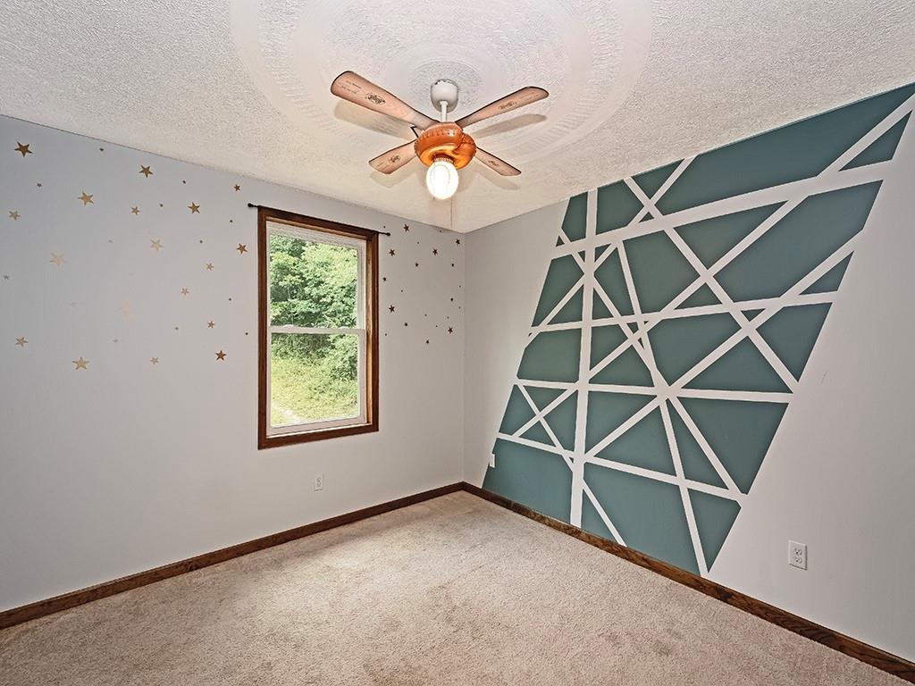 179 Rocks Road Parker, PA 16049 - Photo 22 of 29 an empty room with ceiling fan and window