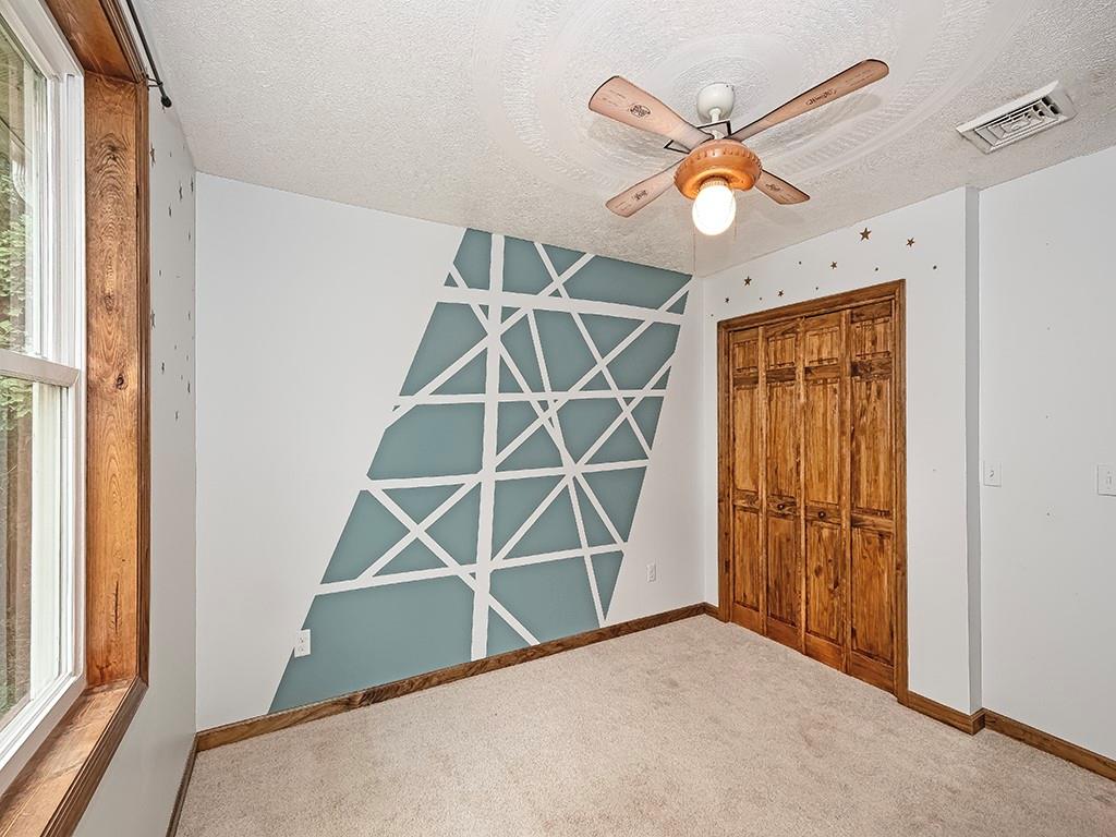 179 Rocks Road Parker, PA 16049 - Photo 23 of 29 an empty room with ceiling fan and window