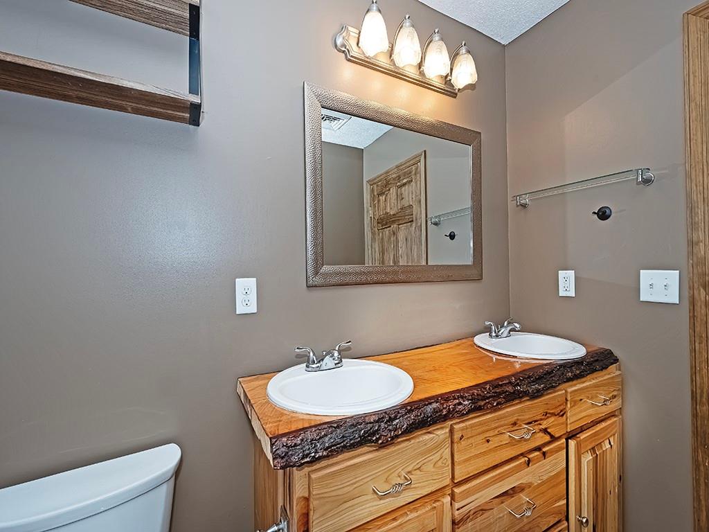 179 Rocks Road Parker, PA 16049 - Photo 24 of 29 a bathroom with a granite countertop sink a light fixture and a mirror