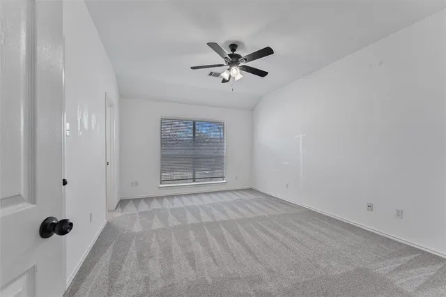 a view of empty room with a fan