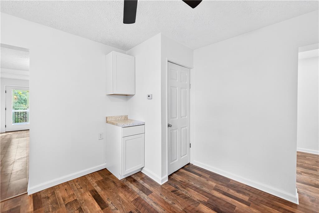 235 Little Summit Road Dunbar, PA 15431 - Photo 15 of 31 an empty room with wooden floor and cabinet