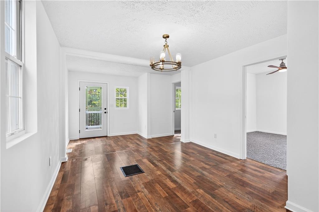 235 Little Summit Road Dunbar, PA 15431 - Photo 16 of 31 a view of an empty room with wooden floor and a window