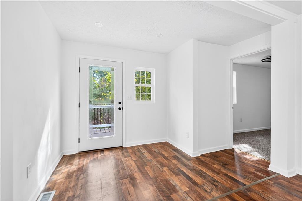 235 Little Summit Road Dunbar, PA 15431 - Photo 17 of 31 an empty room with wooden floor and windows
