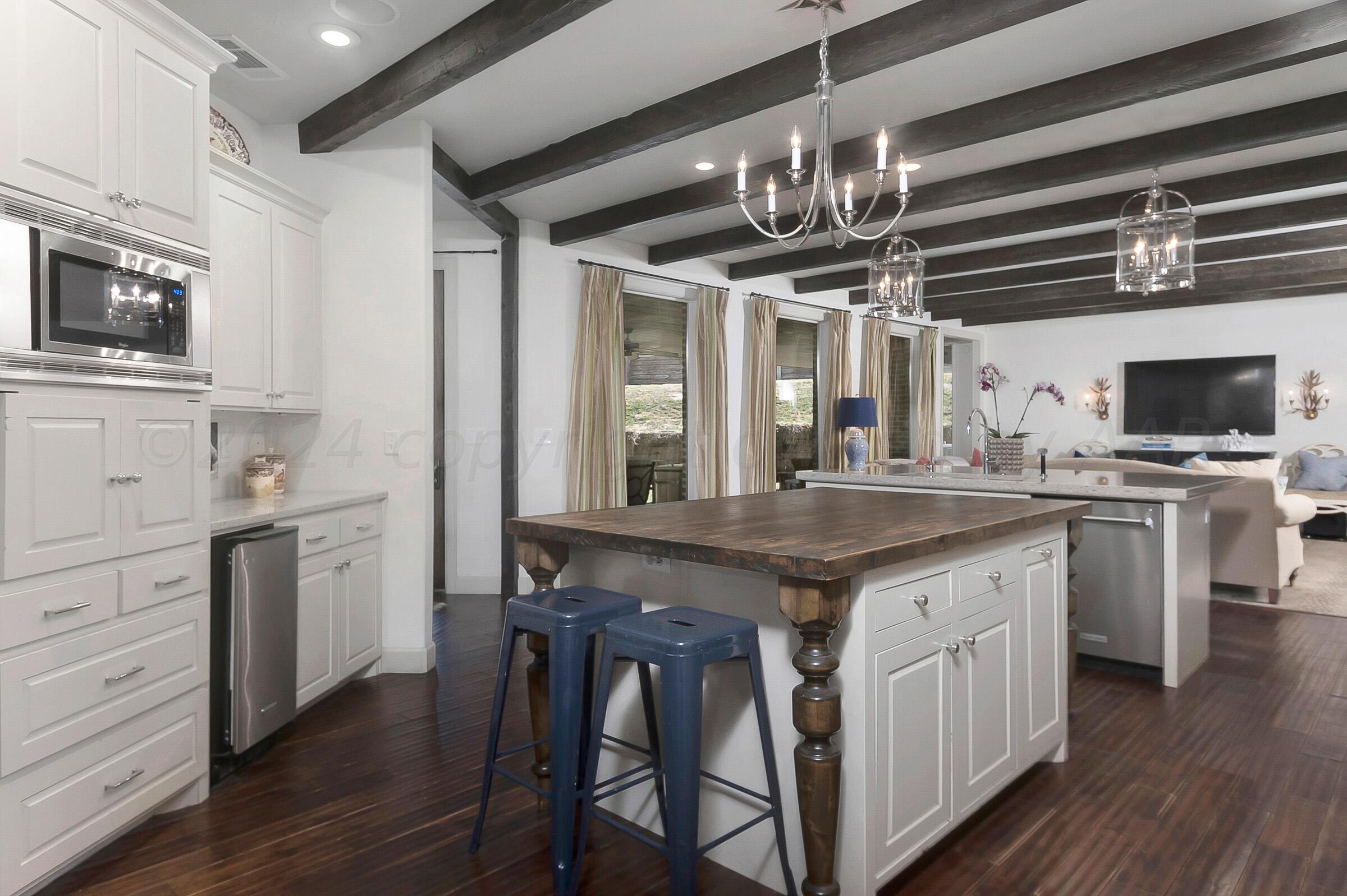 6107 Blue Sage Circle Amarillo, TX 79124 - Photo 16 of 79 a kitchen with stainless steel appliances kitchen island granite countertop a stove a sink and a microwave