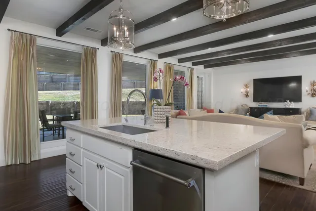a kitchen with a refrigerator and white cabinets