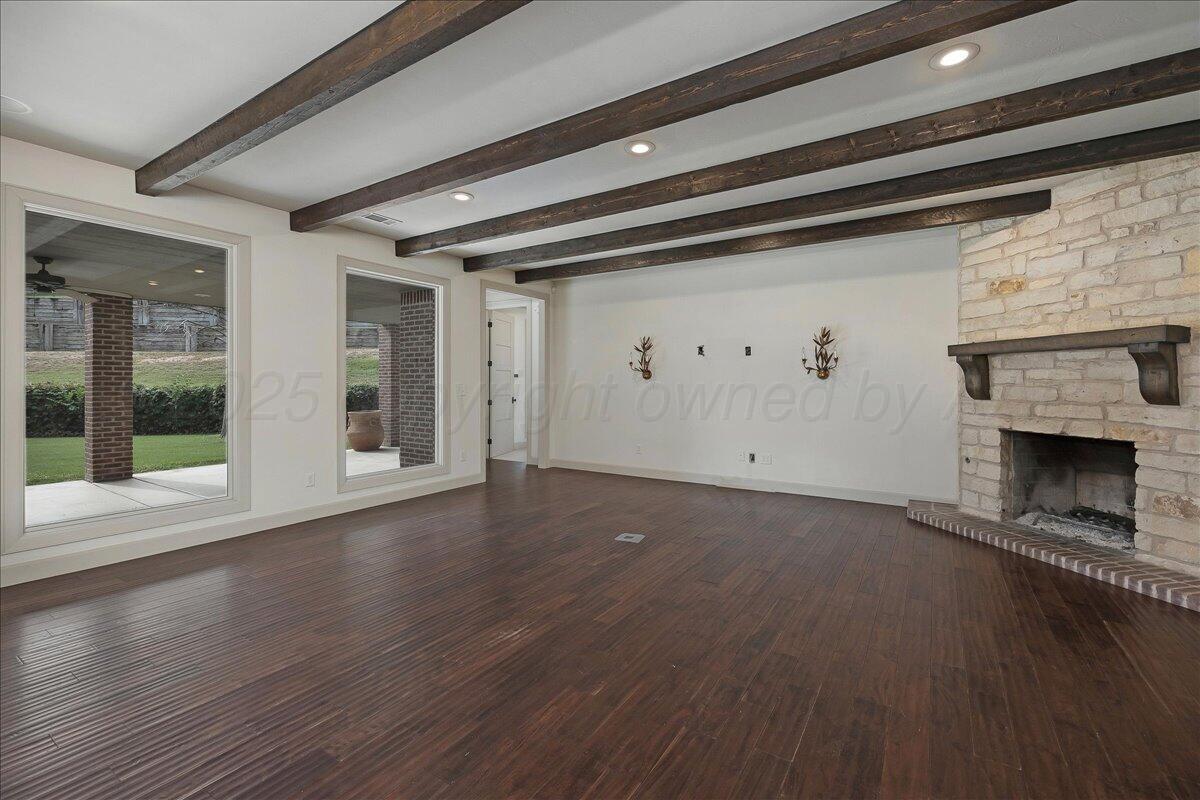 6107 Blue Sage Circle Amarillo, TX 79124 - Photo 18 of 79 a view of an empty room with wooden floor fireplace and a window
