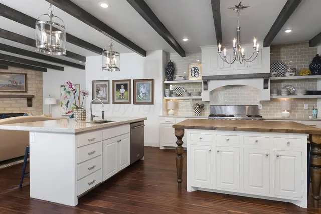 a kitchen with granite countertop a white cabinets and sink